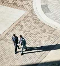 two men walking in courtyard